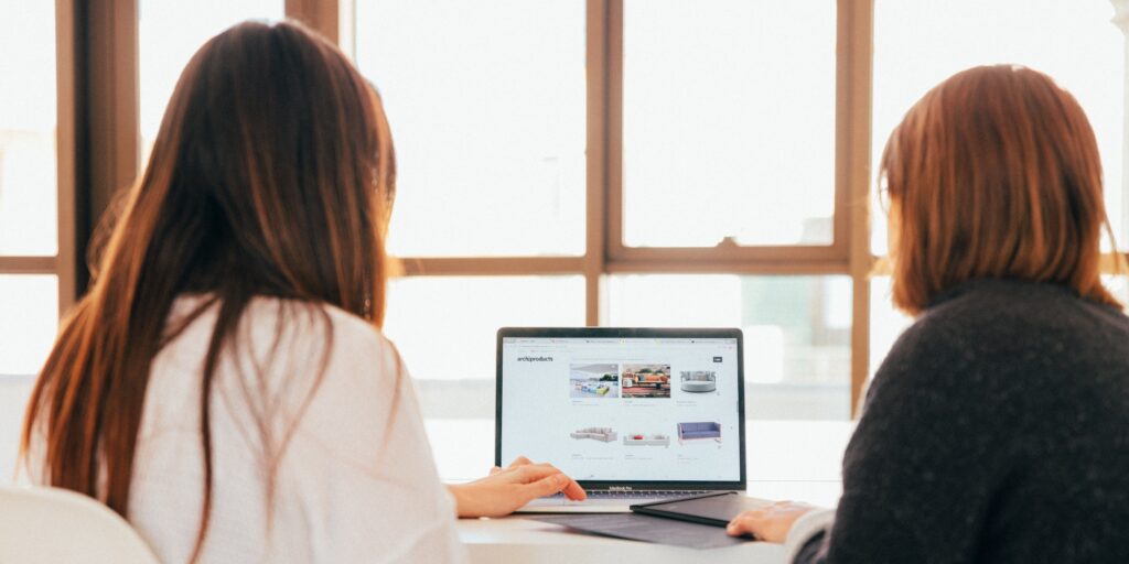 People work on customizing their website on an e-commerce platform.